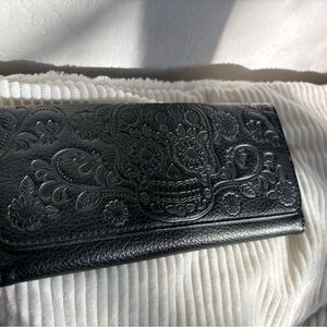 Black Leather Wallet with Embossed Design and Zipper Closure